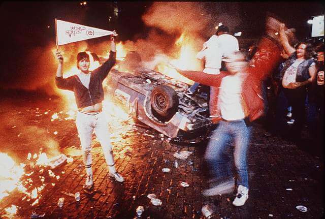 The infamous photograph of rioting Detroit Tigers fans partying near an overturned Detroit Police car outside of Tiger Stadium