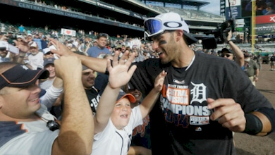 Tigers' outfielder J.D. Martinez celebrates with fans after the team clinched the division title on Sunday.