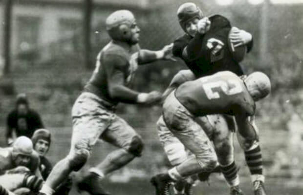 Members of the 1942 Lions attempt to stop a ball carrier for the Chicago Cardinals.