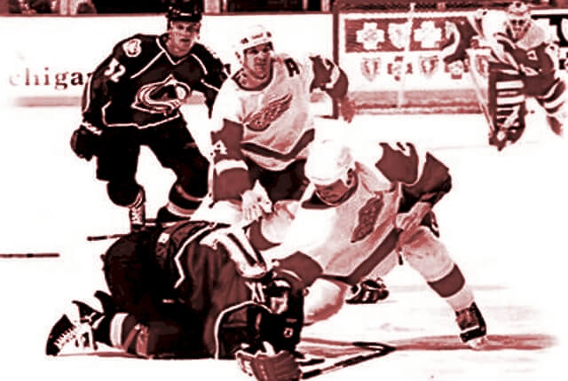 Colorado's Claude Lemieux crouches on the ice as Detroit's Darren McCarty pummels him with punches on March 26, 1997 at Joe Louis Arena.
