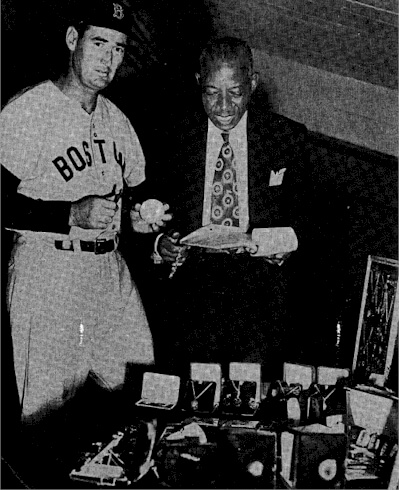 Chicago-based Jeweler Clarence Wadley shows Boston star outfielder Ted Williams some of his inventory.